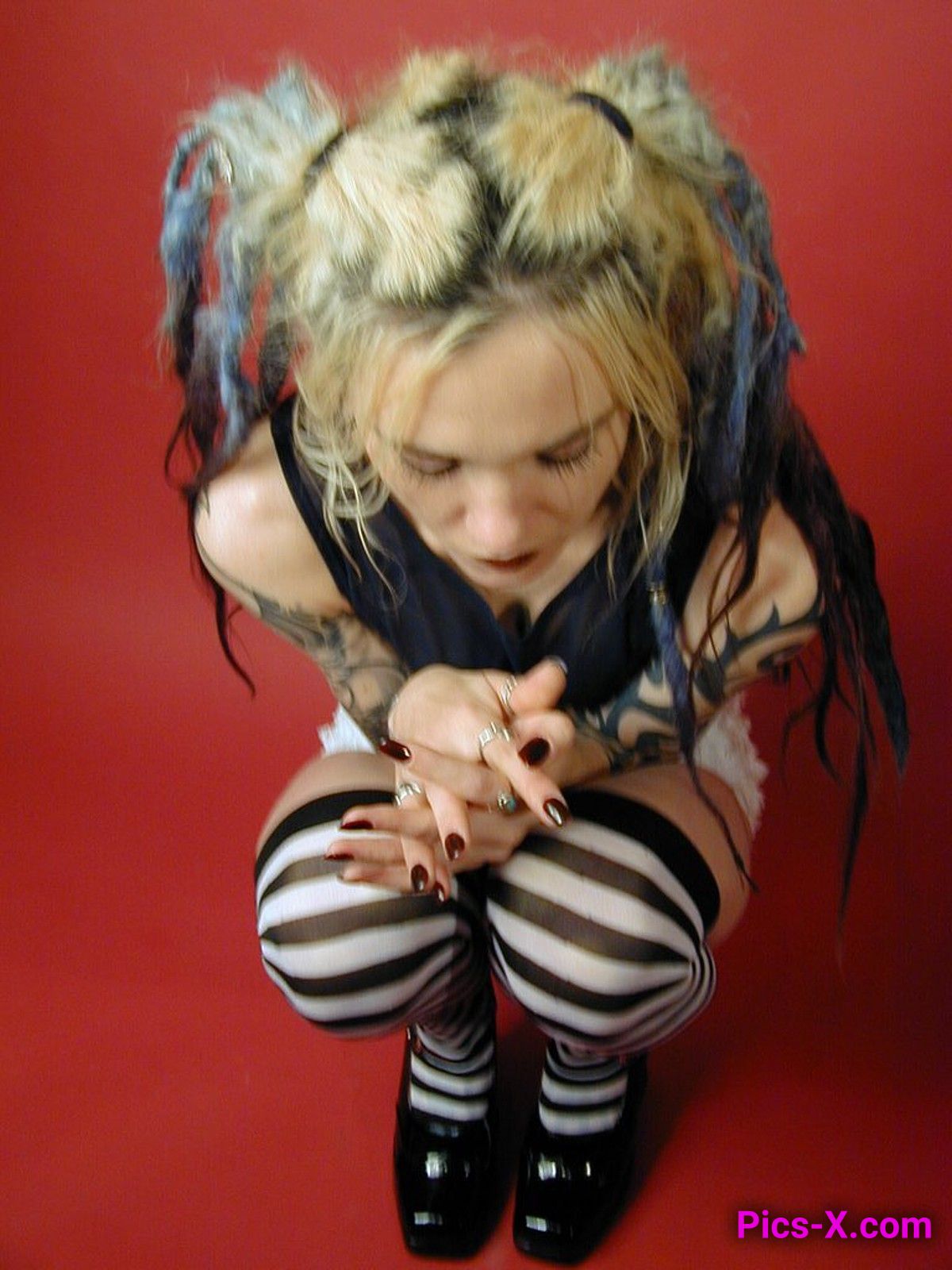 A cute goth girl posing in striped socks then naked - Punk Rock Girlfriend - Image 3